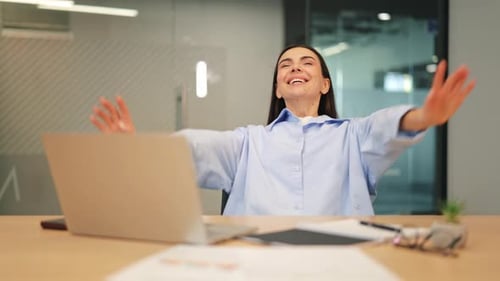 Happy Businesswoman Celebrates Success at Work
