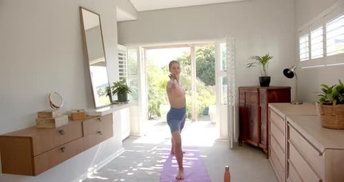 Woman Practicing Yoga in a Modern Home Studio