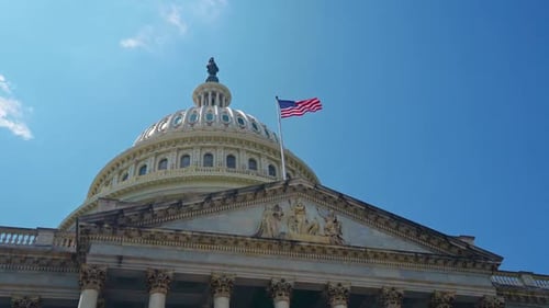 US Capitol Building Dome and American Flag Waving