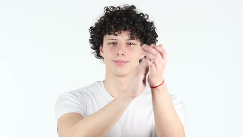 Smiling Young Man Clapping Hands in Studio