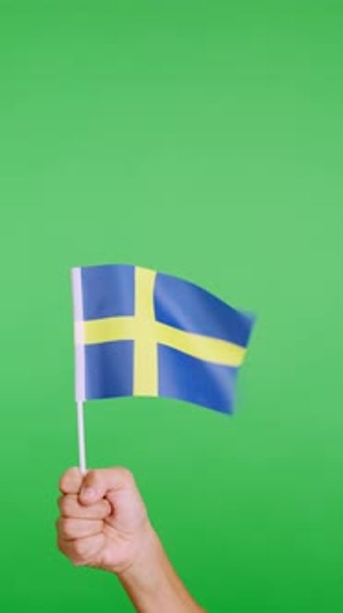 Hand Lifting a Swedish Pennant While Waving By the Wind