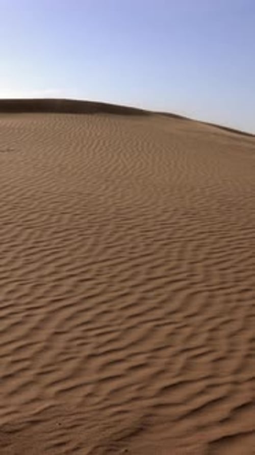 Sand Blowing Over Sand Dunes in Desert