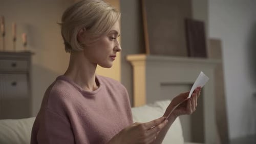 Woman Reads a Letter with Shocking News