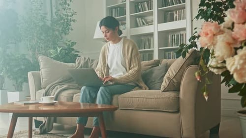 Woman Working on Laptop at Home