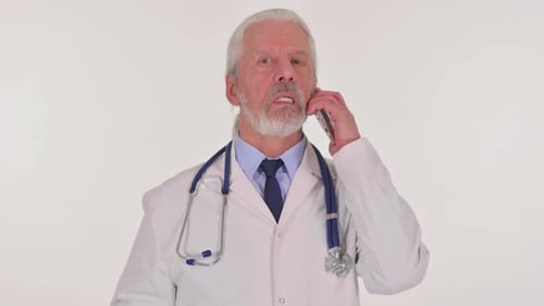 Senior Doctor in White Coat Talks on Phone