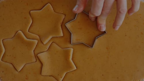 Star Shaped Cookies Being Cut from Dough