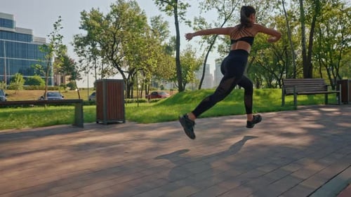 Young Woman Runs in Park on Sunny Day
