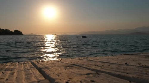 Golden Sunset Over Calm Ocean from Dock