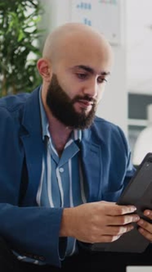 Vertical Video Startup Worker Using Tablet in Office
