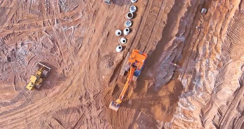 Construction Site Excavator Digging from Birds Eye View