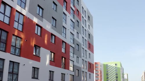 Drone View Flying Near Modern Tall Apartment Building with Colorful Wall Located in New Urban