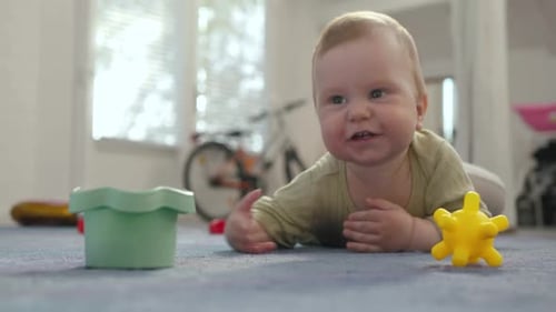 Happy Baby Lying on Stomach with Toys
