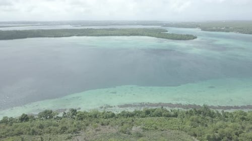 Aerial view of Jesus statue with beautiful beach view in Maluku island, Indonesia