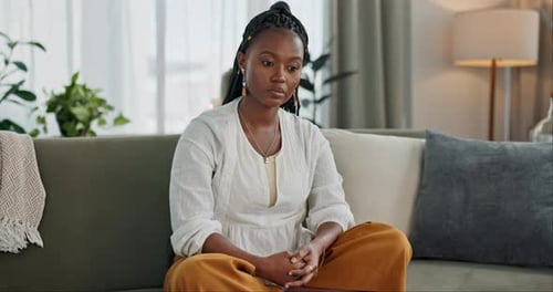 Young Adult Woman Sitting on Sofa Indoors