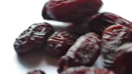 Close Up of Dates on a White Surface