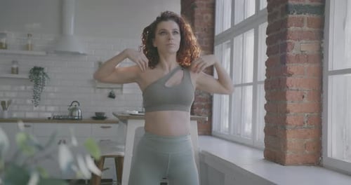 Woman Exercising at Home with Arm Rotations