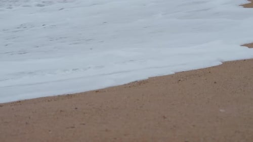 Plastic bottle on the beach, pollution, garbage, waves in slow motion, ecology, pollution