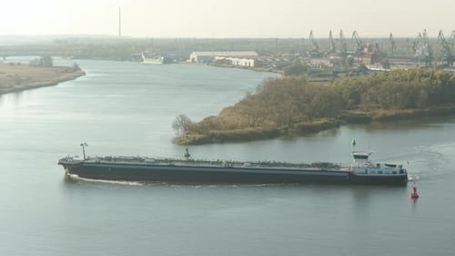 Crude oil tanker navigates serene waters on a bright day, showcasing the vital role of maritime