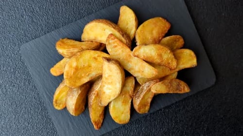 Potato wedges baked with garlic, herbs, and spices for lunch. Potato wedges