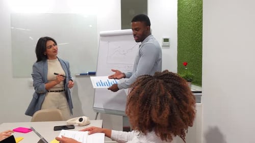 Business Team Analyzing Charts in Coworking Office