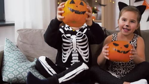 Children in Costume Holding Jack O' Lanterns Smiling