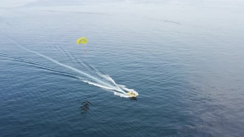 Aerial view of a person doing parasail in Sicily, Italy.
