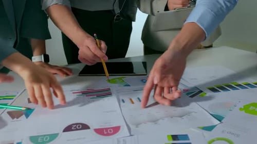 Team of business people working together in the meeting room office analysts strategizing on charts