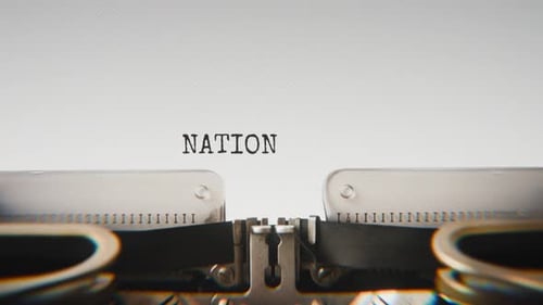 Old mechanical typewriter typing National Security in a close-up view.