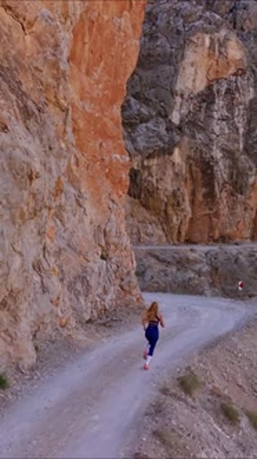 Female Athlete Running in Canyon