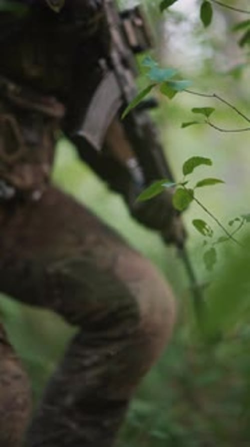 With Specialized Equipment and Backpacks in Tow the Soldiers Advance in the Forest