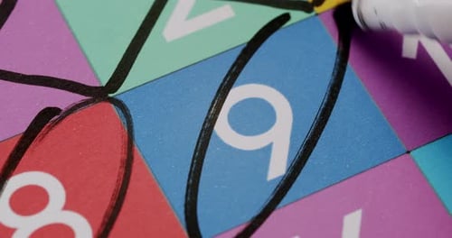 Number Nine Being Circled on Colorful Board