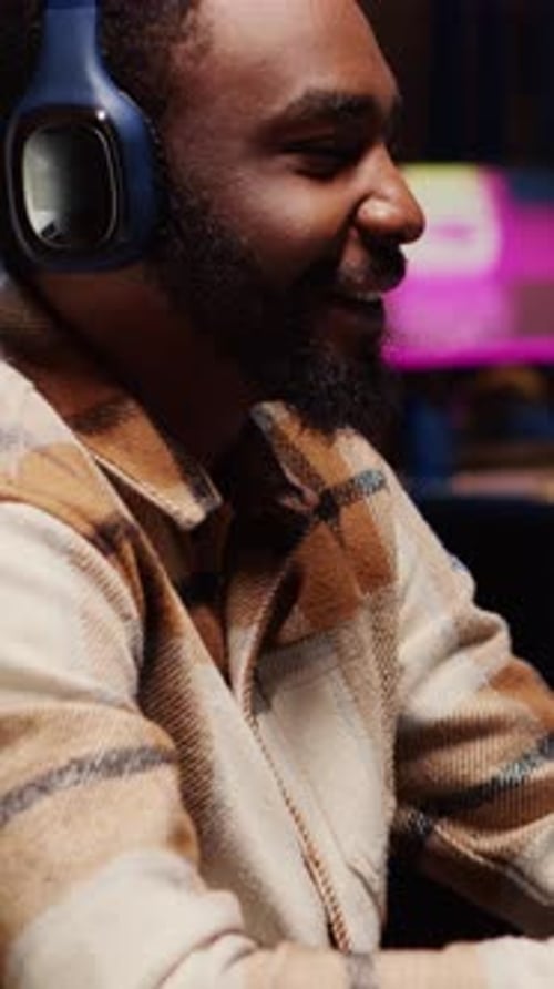 Young Adult Concentrating, Wearing Headphones at Night