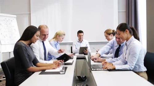 Business Team Collaborating at Conference Table in Office