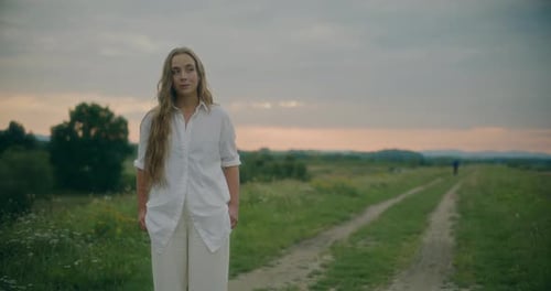 Woman Looking Away Standing In Meadow