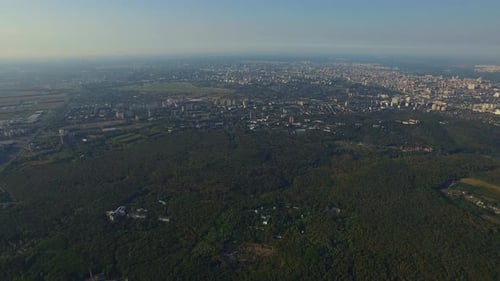 Modern city architecture and green agricultural fields in Ukraine aerial view