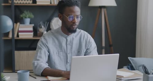 Man Working at Laptop in Home Office