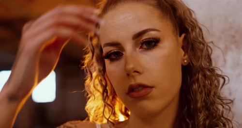 Tattooed woman with fire explosion in dramatic cinematic scene, close up