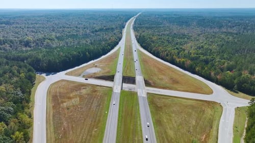 Aerial View of Freeway Overpass Junction with Fast Moving Traffic Cars and Trucks in American Rural