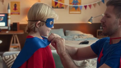 Loving Father Helps Son with Superhero Costume