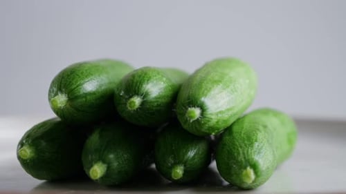 Cucumbers Rotates on a White Background Fresh Green Cucumbers Stacked on Top of Each Other
