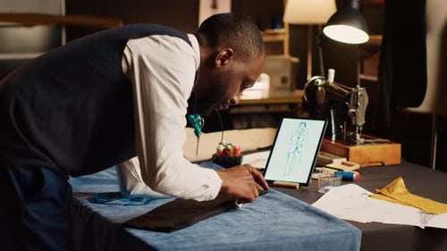 Craftsman Measuring Fabric in Atelier