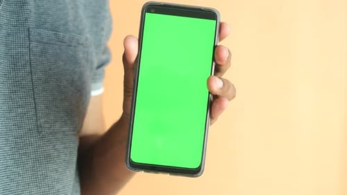 Close Up of Young Man Hand Using Smart Phone with Green Screen