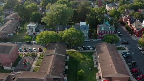 Rising aerial of urban America city, Lancaster Pennsylvania USA. Homes and apartment buildings durin