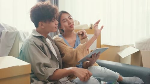 couple use digital tablet online shopping furniture from decoration store in living room at home.