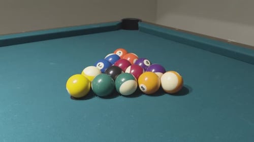 Arranged pool balls ready for the game to begin on a green felt table