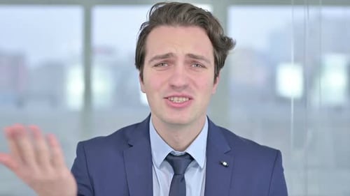 Professional Man Explaining and Gesturing in Office