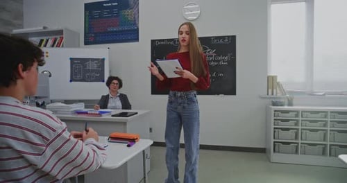 Teacher Lecturing Students in School Classroom Setting