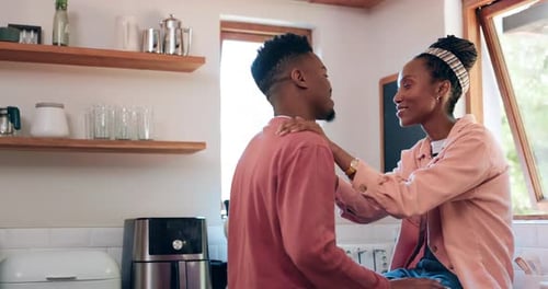 Affectionate Young Couple Embracing in a Cozy Kitchen