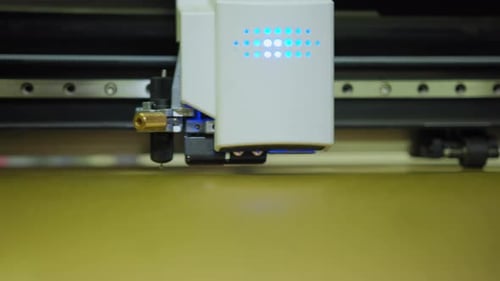 Close Up Shot of Commercial Plotter is Cutting a Paper