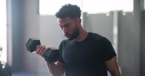 Bodybuilder, dumbbell and workout in gym for biceps, muscle growth and strong arms with sweat